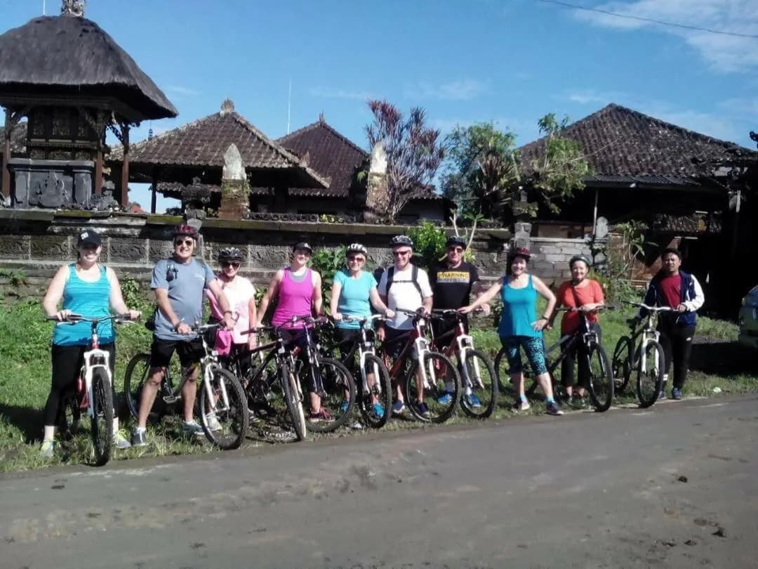 Guests with mountain bikes outside a Balinese temple