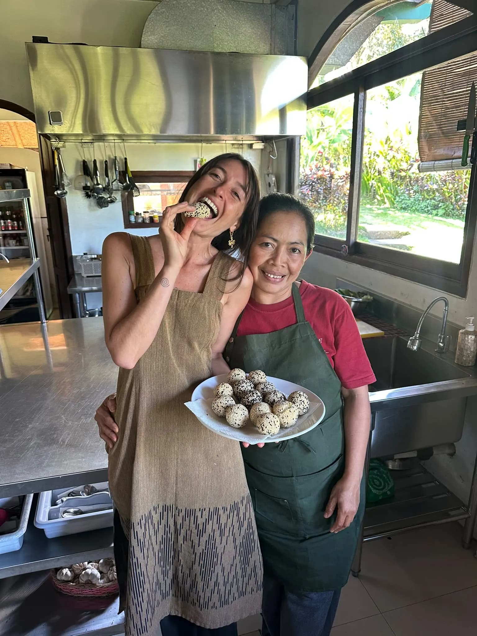 A guest sharing a laugh with the cook during a cooking class in the kitchen