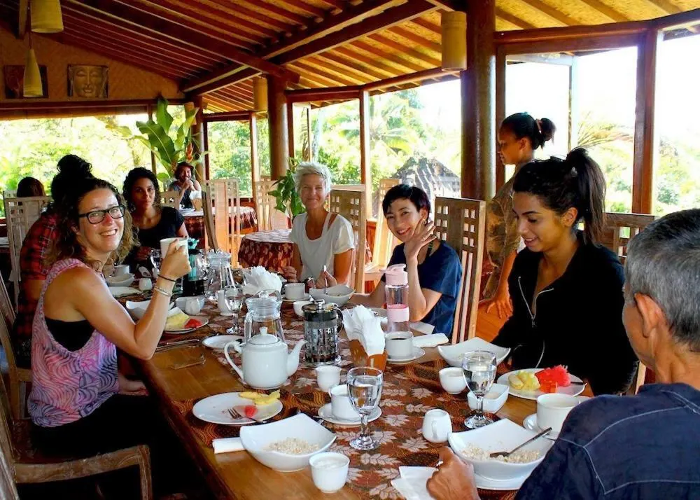 Guests sharing a communal breakfast in the open-air restaurant