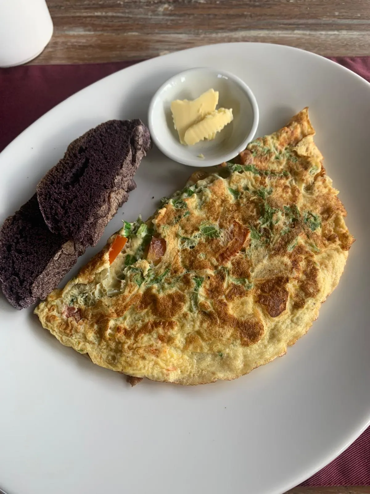 A herb and tomato omelette with black-rice bread