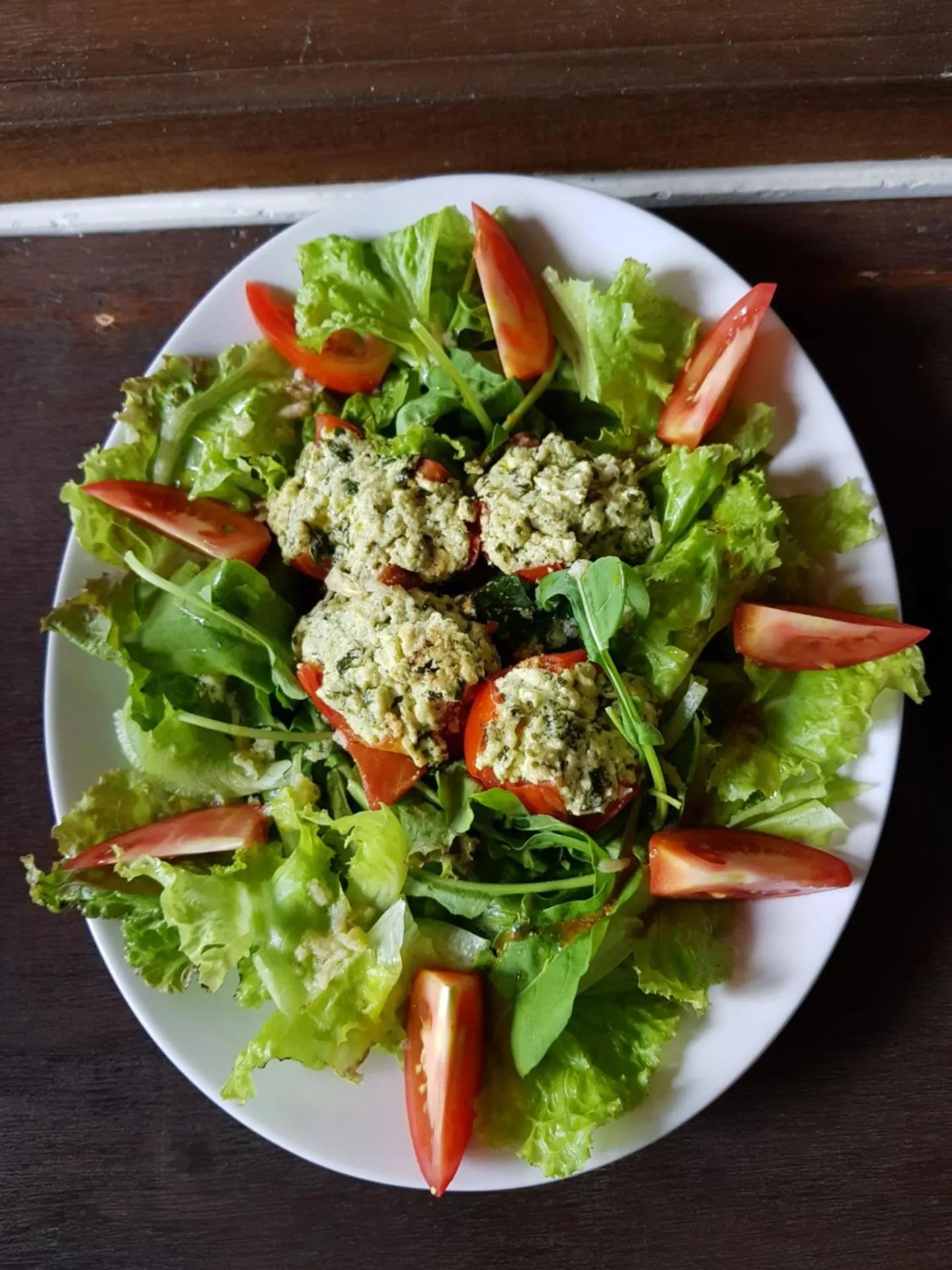 Fresh garden salad with pesto-stuffed tomatoes