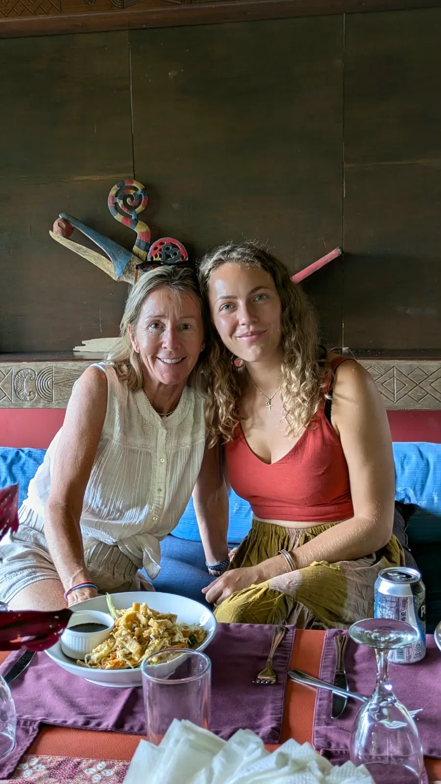 Two guests at lunch on the restaurant's blue banquette