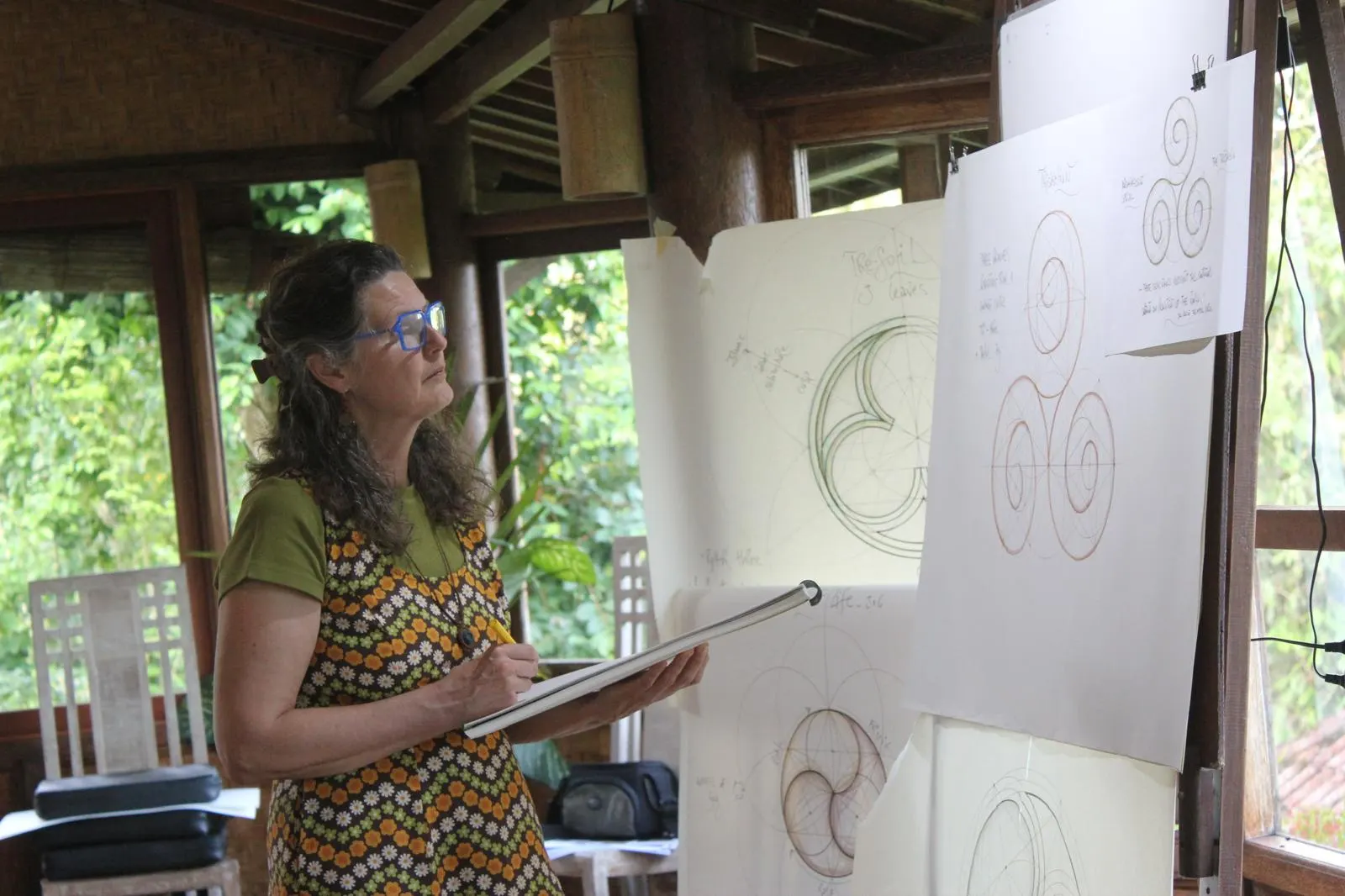 Studying easels of spiral geometry drawings in an open timber pavilion