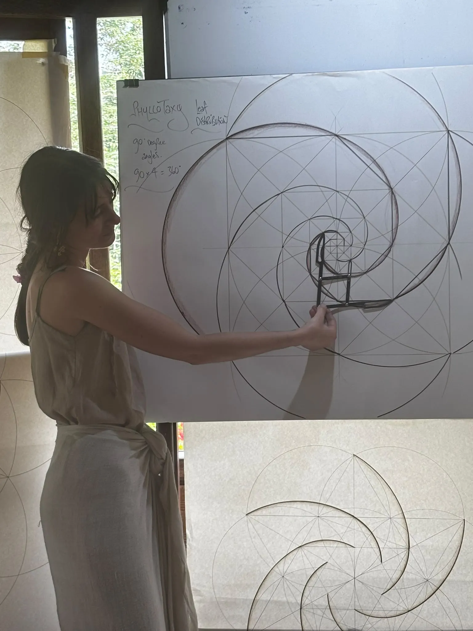 Tracing a golden-ratio spiral with a compass on the whiteboard
