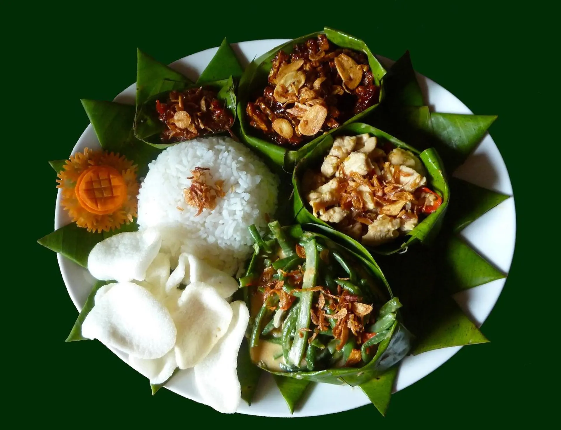 Balinese mixed-rice plate served in banana-leaf cups