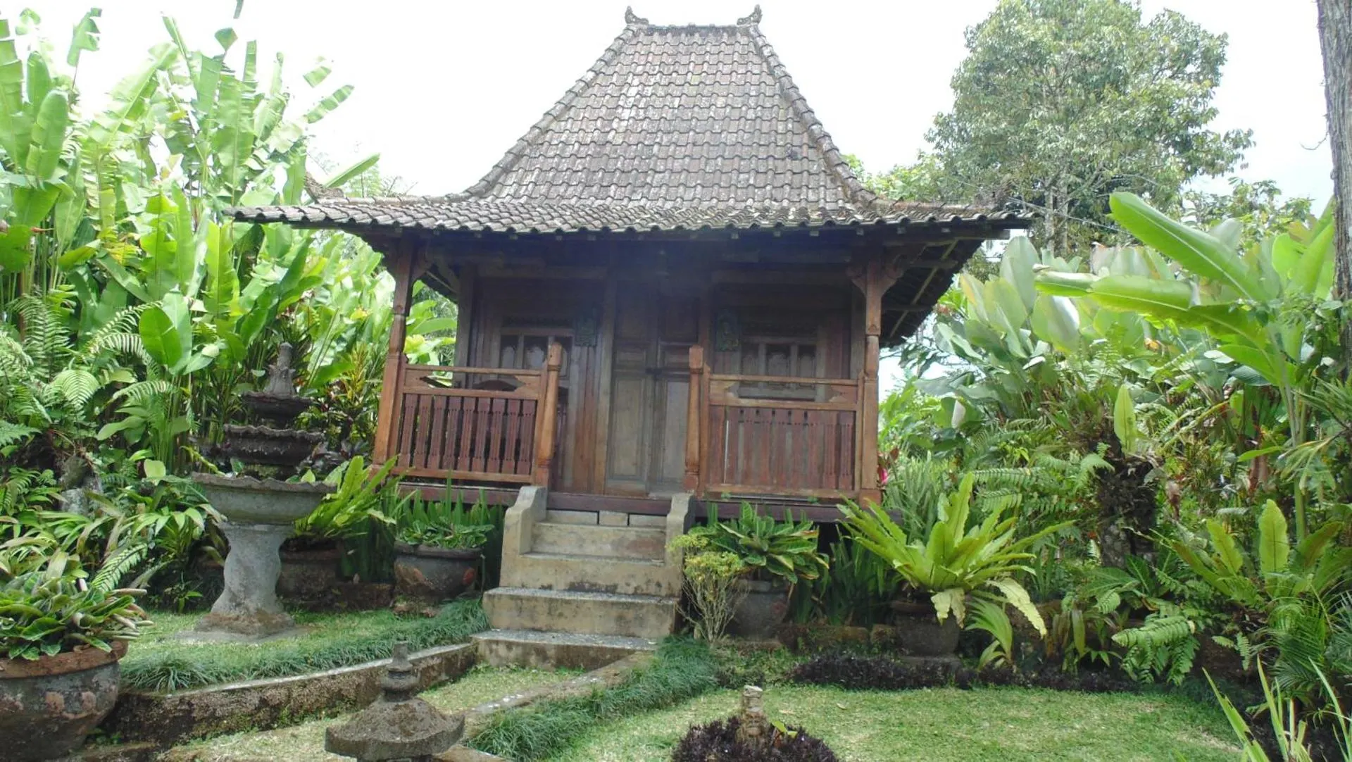 A handcrafted Javanese teak house with carved doors
