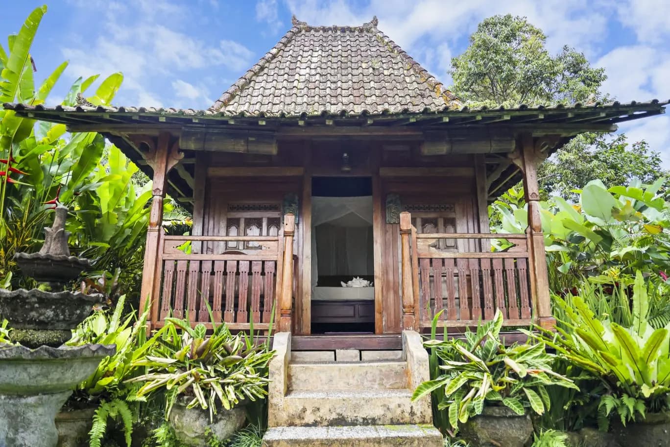 A traditional antique Javanese house wrapped in jungle at Bali Mountain Retreat