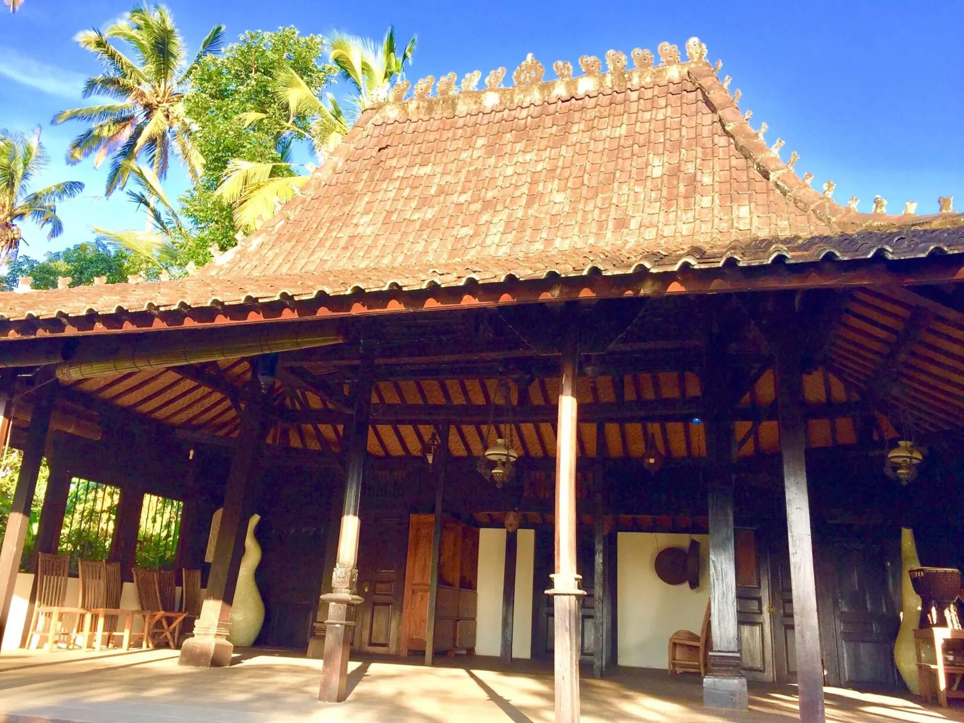 Open-sided Javanese joglo pavilion with a carved tiled roof
