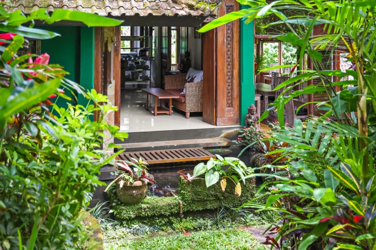 The restaurant opening to a tropical garden and pond